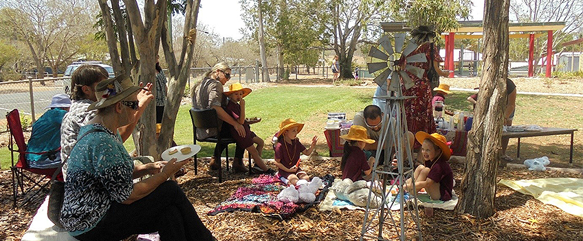 parent helpers on school excursion in the park at luch time